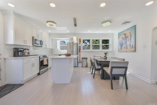 Dining room, Interior, Kitchen, Pendant Lights, Recessed Lighting, Stainless Steel Appliances, Wood Texture Flooring