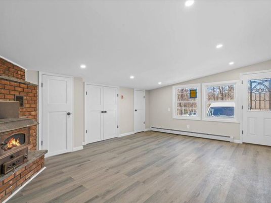 Empty room, Fireplace, Interior, Recessed Lighting, Stone Walls, Wood Texture Flooring