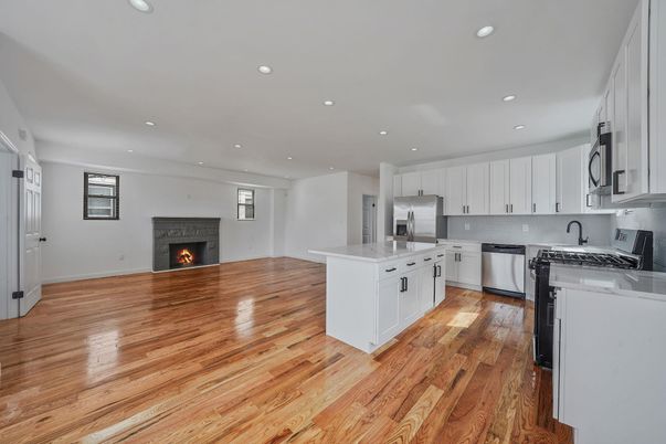 Fireplace, Interior, Kitchen, Recessed Lighting, Stainless Steel Appliances, Wood Texture Flooring