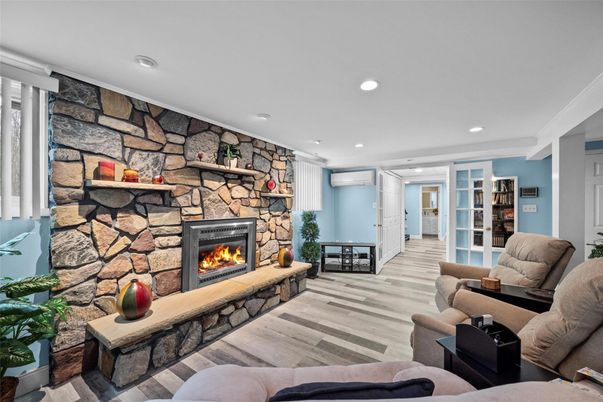 Fireplace, Interior, Living room, Recessed Lighting, Stone Walls, Wood Texture Flooring