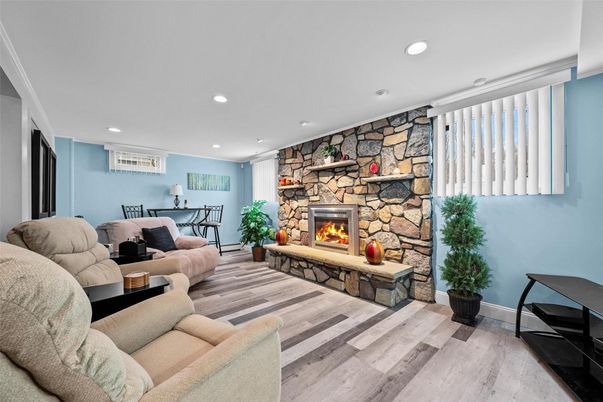 Fireplace, Interior, Living room, Recessed Lighting, Stone Walls, Wood Texture Flooring
