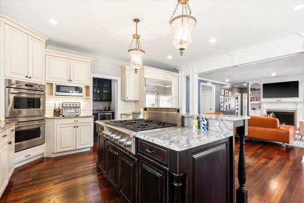 Fireplace, Interior, Kitchen, Living room, Pendant Lights, Recessed Lighting, Stainless Steel Appliances, Wood Texture Flooring
