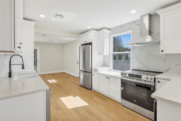 Interior, Kitchen, Marble Walls, Recessed Lighting, Stainless Steel Appliances, Wood Texture Flooring
