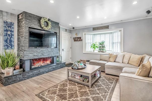 Fireplace, Interior, Living room, Recessed Lighting, Stone Walls, Wood Texture Flooring