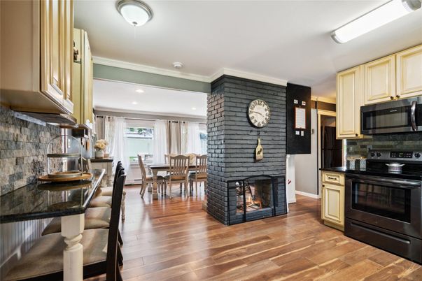 Dining room, Fireplace, Interior, Kitchen, Recessed Lighting, Stone Walls, Wood Texture Flooring