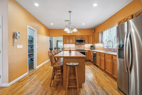 Dining room, Interior, Kitchen, Pendant Lights, Recessed Lighting, Stainless Steel Appliances, Wood Texture Flooring