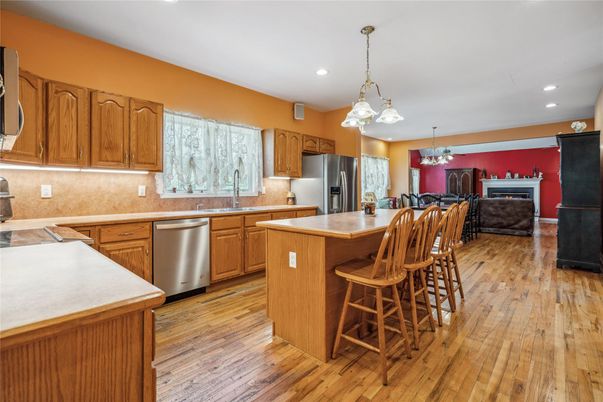 Chandelier, Dining room, Fireplace, Interior, Kitchen, Pendant Lights, Recessed Lighting, Stainless Steel Appliances, Wood Texture Flooring