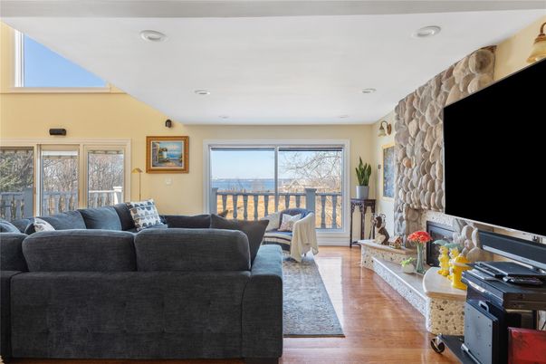 Fireplace, Interior, Living room, Recessed Lighting, Stone Walls, Wood Texture Flooring