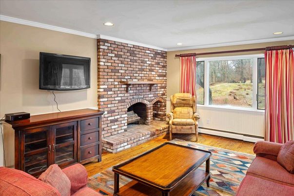 Fireplace, Interior, Living room, Recessed Lighting, Stone Walls, Wood Texture Flooring