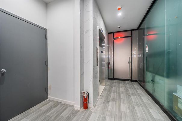 Elevator, Interior, Marble Walls, Recessed Lighting, Wood Texture Flooring