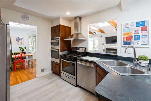 Dining room, Fireplace, Interior, Kitchen, Recessed Lighting, Stainless Steel Appliances, Wood Texture Flooring