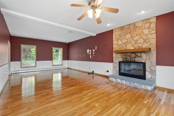 Empty room, Fireplace, Interior, Recessed Lighting, Stone Walls, Wood Texture Flooring