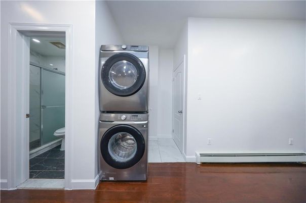 Bathroom, Interior, Marble, Marble Walls, Recessed Lighting, Utility Closets, Washer, Wood Texture Flooring