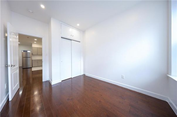Empty room, Interior, Kitchen, Recessed Lighting, Stainless Steel Appliances, Wood Texture Flooring