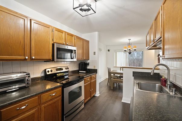 Chandelier, Dining room, Interior, Kitchen, Stainless Steel Appliances, Wood Texture Flooring