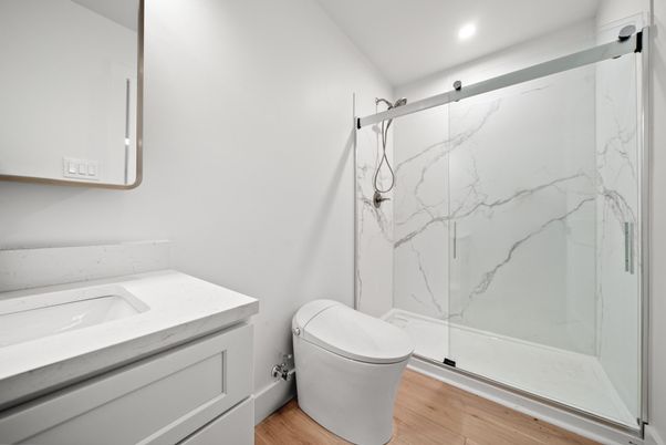 Bathroom, Glass Shower, Interior, Marble Walls, Recessed Lighting, Wood Texture Flooring
