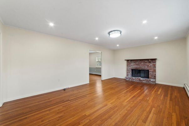 Empty room, Fireplace, Interior, Recessed Lighting, Stone Walls, Wood Texture Flooring