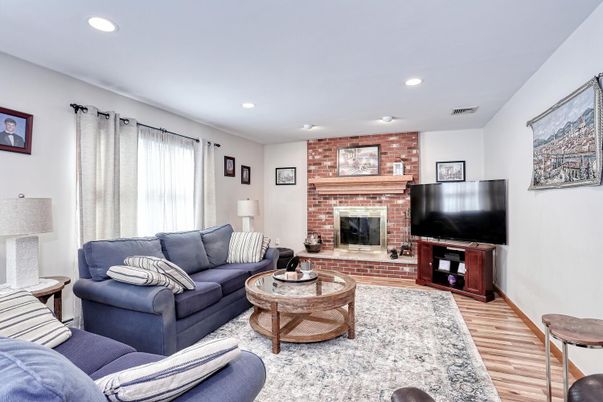 Fireplace, Interior, Living room, Recessed Lighting, Stone Walls, Wood Texture Flooring