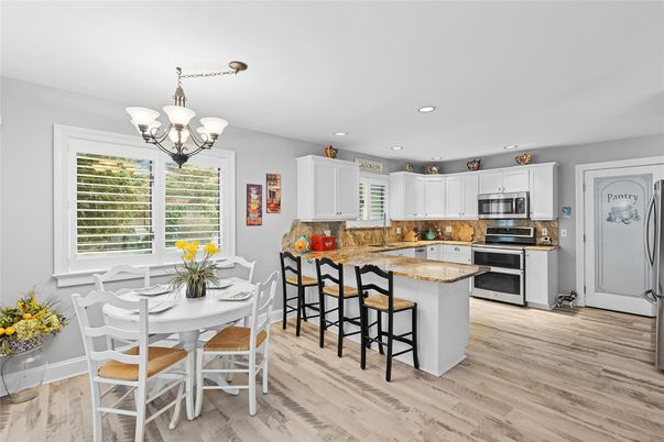 Chandelier, Dining room, Interior, Kitchen, Recessed Lighting, Stainless Steel Appliances, Wood Texture Flooring
