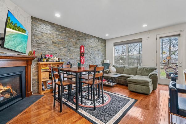Dining room, Fireplace, Interior, Living room, Recessed Lighting, Stone Walls, Wood Texture Flooring