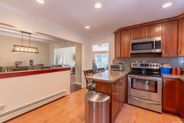 Dining room, Interior, Kitchen, Pendant Lights, Recessed Lighting, Stainless Steel Appliances, Wood Texture Flooring