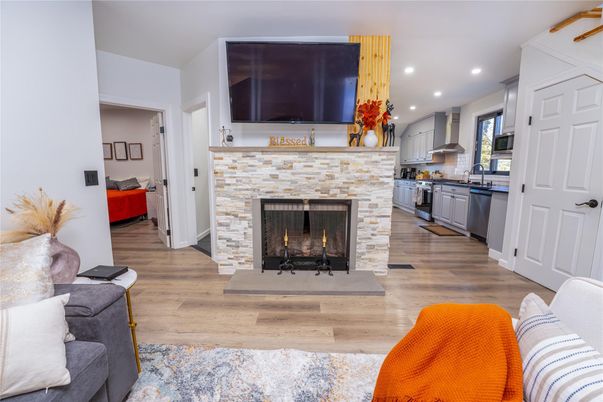 Fireplace, Interior, Kitchen, Recessed Lighting, Stainless Steel Appliances, Wood Texture Flooring
