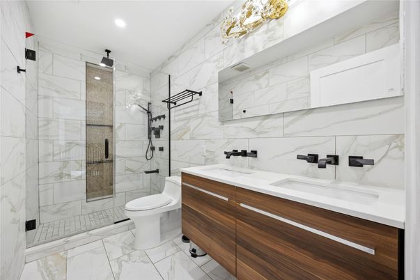 Bathroom, Dual Sink Vanities, Glass Shower, Interior, Marble, Marble Walls, Recessed Lighting