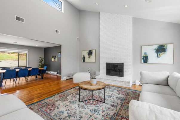 Dining room, Fireplace, Interior, Living room, Recessed Lighting, Stone Walls, Wood Texture Flooring