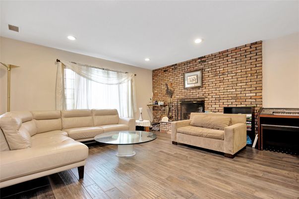 Fireplace, Interior, Living room, Recessed Lighting, Stone Walls, Wood Texture Flooring