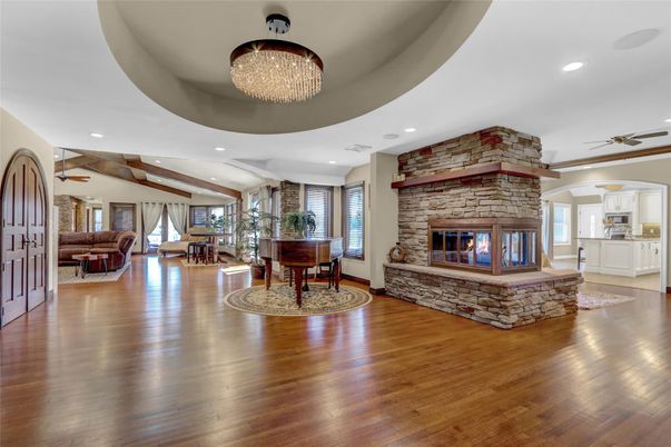 Chandelier, Fireplace, Interior, Living room, Piano, Recessed Lighting, Stone Walls, Wooden Beams, Wood Texture Flooring