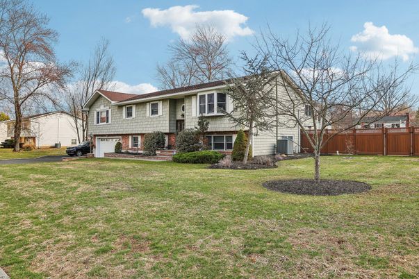 Attached, Backyard, Exterior, Facade, Brick Facade, Raised Ranch