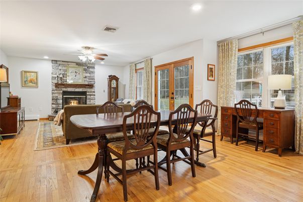 Dining room, Fireplace, Interior, Recessed Lighting, Stone Walls, Wood Texture Flooring