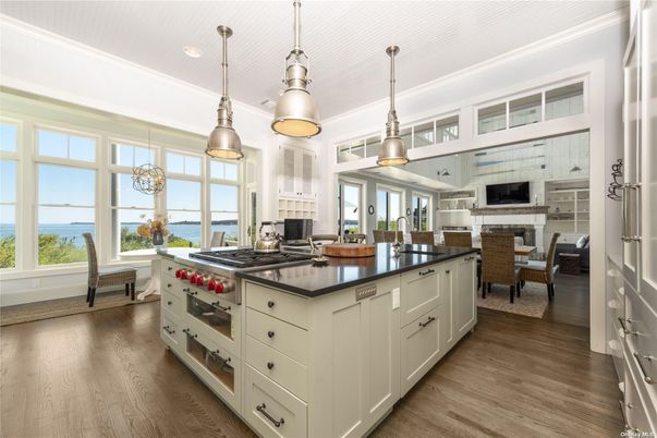 Dining room, Fireplace, Interior, Kitchen, Living room, Pendant Lights, Recessed Lighting, Stainless Steel Appliances, Water, Wood Texture Flooring