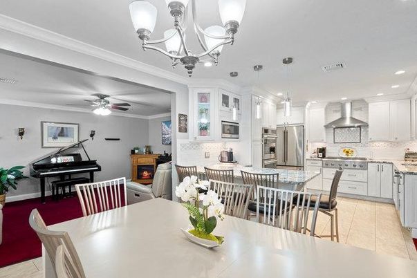 Chandelier, Dining room, Fireplace, Interior, Kitchen, Living room, Pendant Lights, Piano, Recessed Lighting, Stainless Steel Appliances