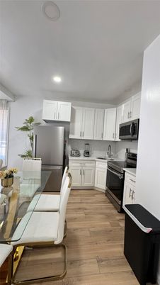 Dining room, Interior, Kitchen, Recessed Lighting, Stainless Steel Appliances, Wood Texture Flooring