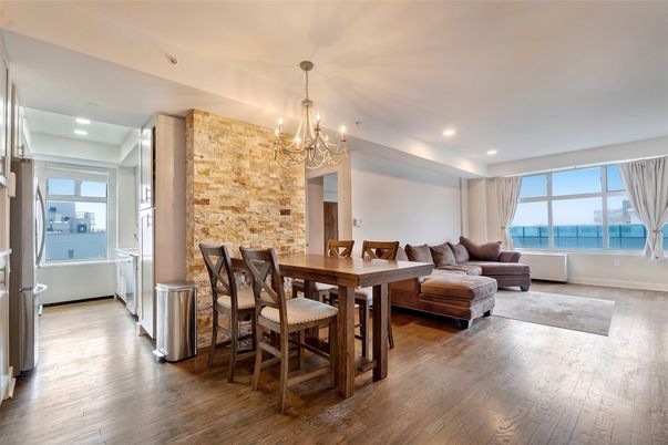 Chandelier, Dining room, Fireplace, Interior, Living room, Recessed Lighting, Stone Walls, Water, Wood Texture Flooring