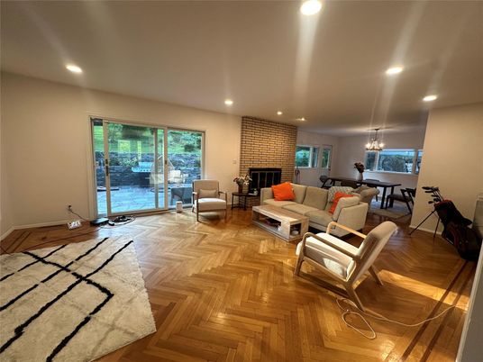 Chandelier, Dining room, Fireplace, Interior, Living room, Pendant Lights, Recessed Lighting, Stone Walls, Wood Texture Flooring