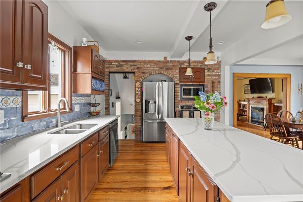 Fireplace, Interior, Kitchen, Pendant Lights, Recessed Lighting, Stainless Steel Appliances, Stone Walls, Wood Texture Flooring