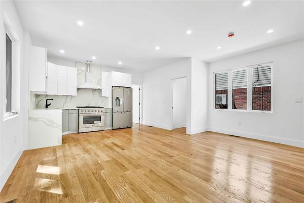 Interior, Kitchen, Marble Walls, Recessed Lighting, Stainless Steel Appliances, Wood Texture Flooring