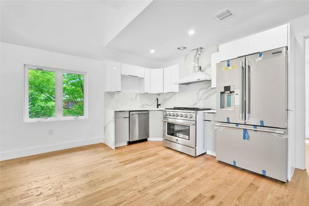 Interior, Kitchen, Marble Walls, Recessed Lighting, Stainless Steel Appliances, Wood Texture Flooring