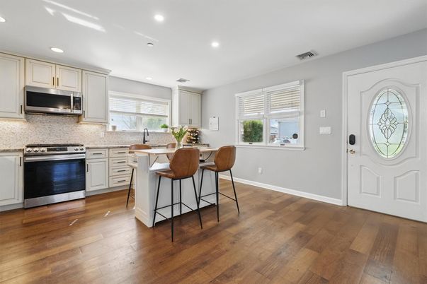 Dining room, Interior, Kitchen, Recessed Lighting, Stainless Steel Appliances, Wood Texture Flooring