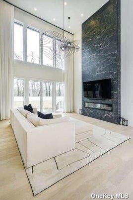 Chandelier, Fireplace, Interior, Living room, Marble Walls, Pendant Lights, Recessed Lighting, Wood Texture Flooring