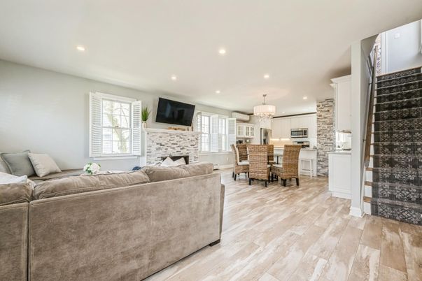 Chandelier, Dining room, Fireplace, Interior, Kitchen, Living room, Pendant Lights, Recessed Lighting, Stainless Steel Appliances, Stone Walls, Wood Texture Flooring