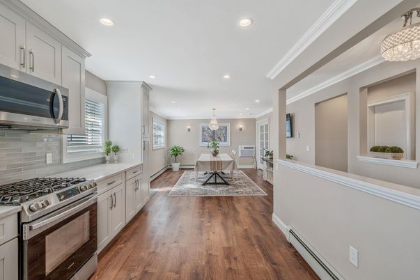 Chandelier, Dining room, Interior, Kitchen, Living room, Pendant Lights, Recessed Lighting, Stainless Steel Appliances, Wood Texture Flooring