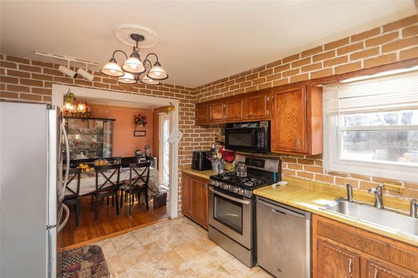 Chandelier, Dining room, Interior, Kitchen, Stainless Steel Appliances, Stone Walls, Wood Texture Flooring