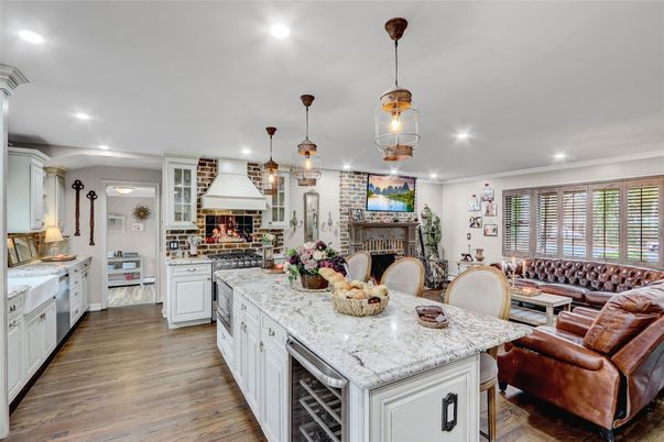 Fireplace, Interior, Kitchen, Living room, Pendant Lights, Recessed Lighting, Stainless Steel Appliances, Stone Walls, Wood Texture Flooring