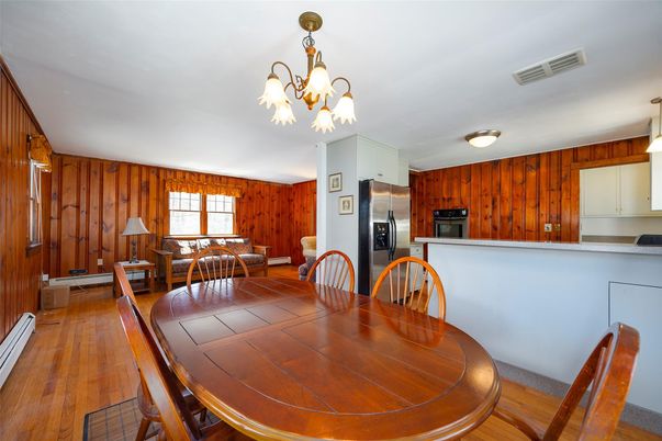 Chandelier, Dining room, Interior, Kitchen, Stainless Steel Appliances, Wood Texture Flooring, Wooden Walls