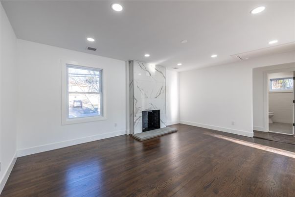 Empty room, Fireplace, Interior, Marble Walls, Recessed Lighting, Wood Texture Flooring