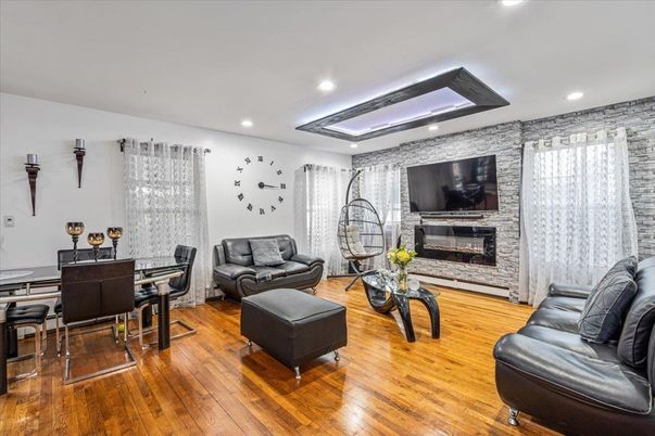 Dining room, Fireplace, Interior, Living room, Recessed Lighting, Stone Walls, Wood Texture Flooring