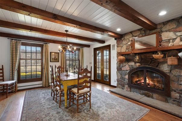 Chandelier, Dining room, Fireplace, Interior, Recessed Lighting, Stone Walls, Wooden Beams, Wood Texture Flooring